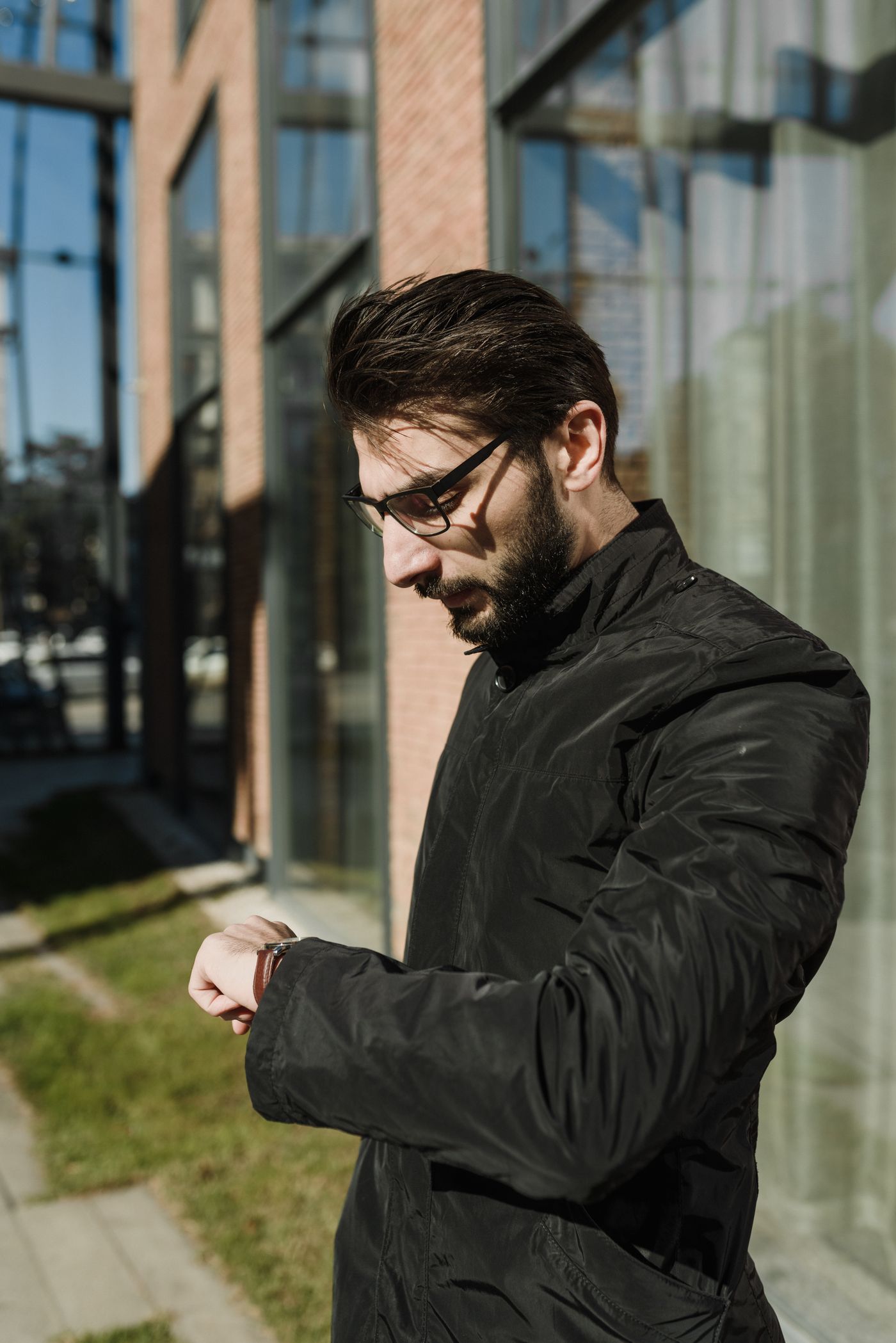 Stylish man checking his wristwatch in the city